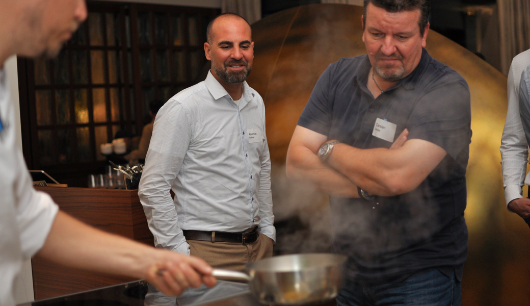 Interessierte und faszinierte Einblicke: Andreas Rohrer, VR-Präsident der Ortsgemeinde Buchs (links), und Carsten Zeiske von der Foxcom AG in Vaduz verfolgen die Künste des Kochs.