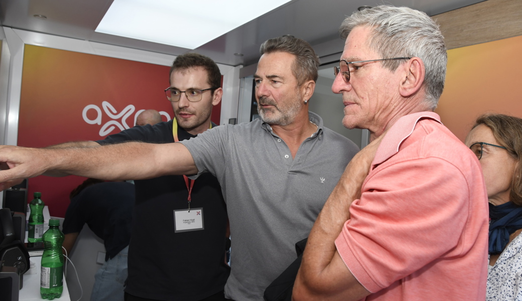 Am meisten interessierten sich die Teilnehmenden, wo die bis zu sieben Windturbinen zu stehen kommen können. Im Windmobil, das vor der Mehrzweckhalle aufgestellt war, erklärte Fabian Hügli (Projektleiter Wind, Axpo, links) entsprechende Visulisierungen.