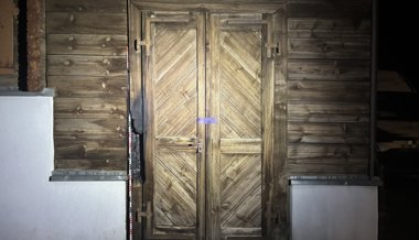 Feuer an Holztüre eines leerstehenden Holzhauses